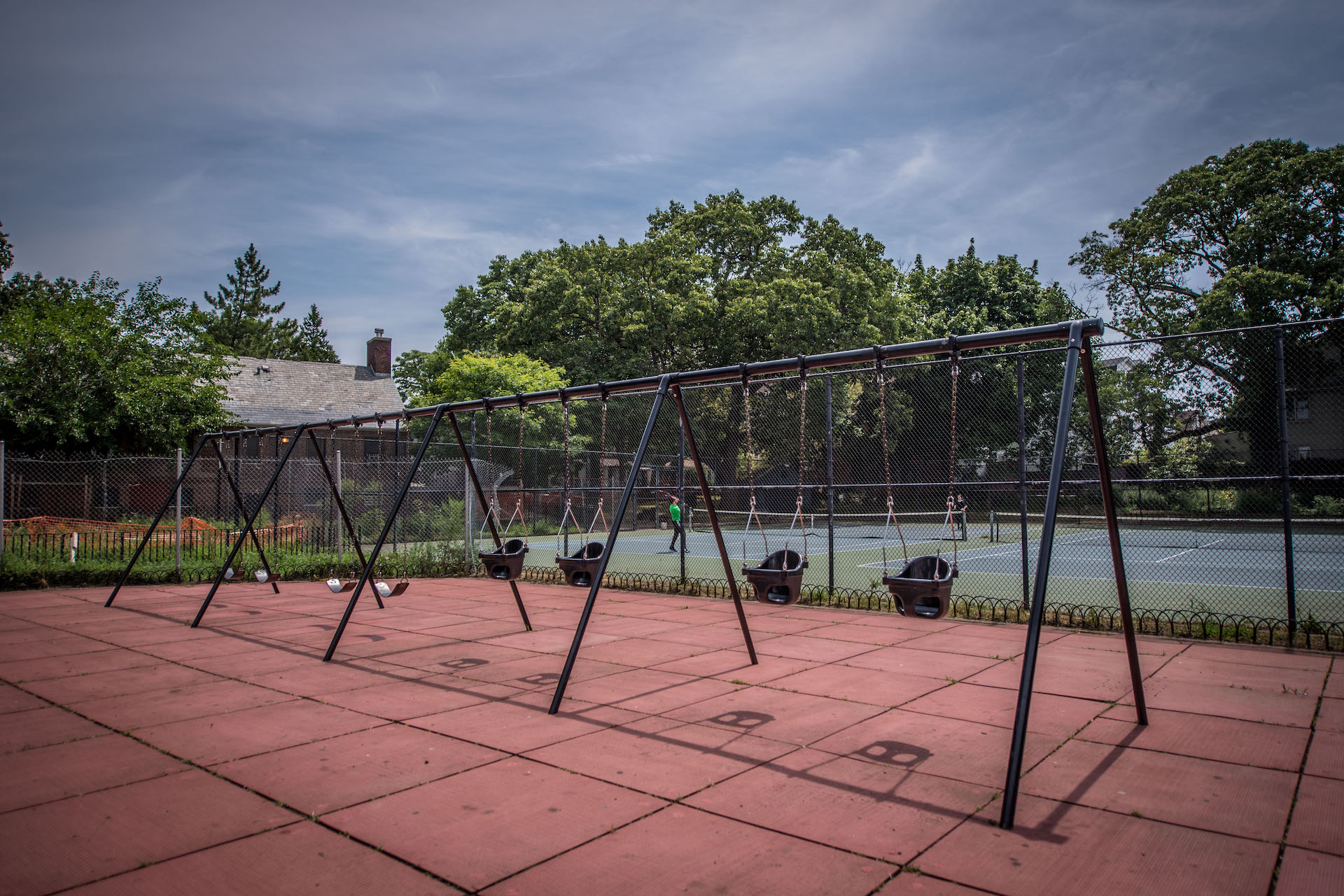 Set of swings near tennis courts at The Vitagraph Apartment park