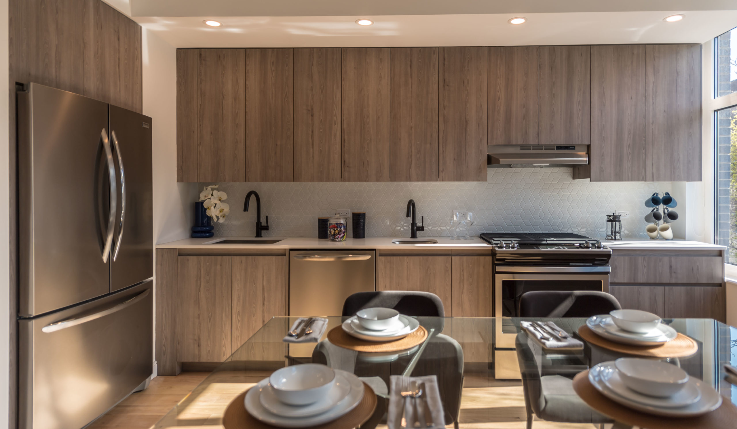 A large kitchen with stainless steel appliances at The Vitagraph Apartments in Brooklyn